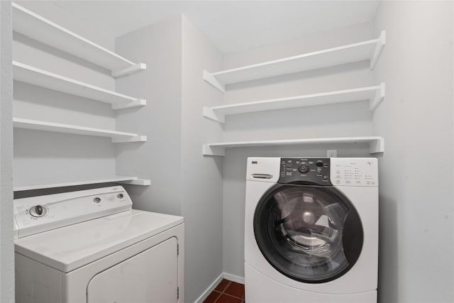 5317 Harvest Ln, Austin, TX 78745 - laundry room with dark tile patterned flooring and washing machine and clothes dryer