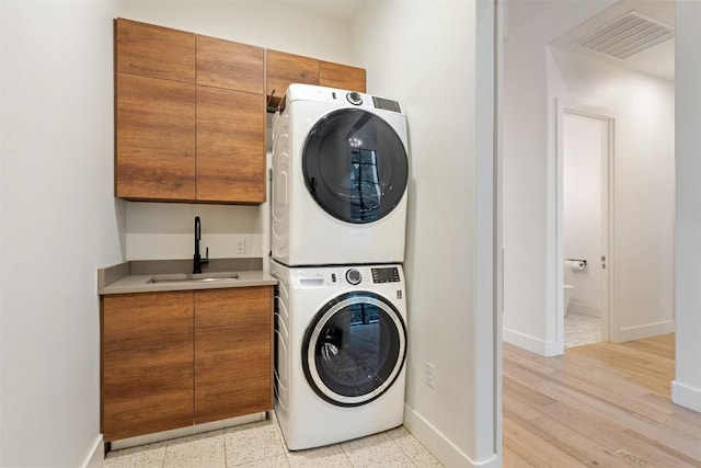 4103 Ridgelea Dr, Austin, TX 78731 - washroom with stacked washer / dryer and cabinet space
