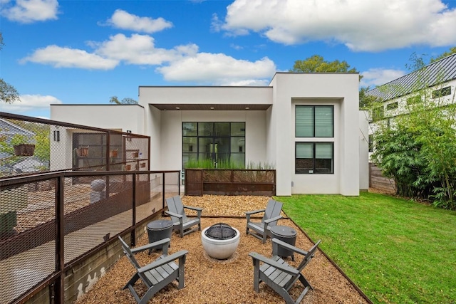 4103 Ridgelea Dr, Austin, TX 78731 - back of property featuring stucco siding and an outdoor fire pit