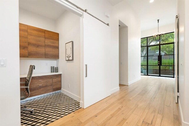 4103 Ridgelea Dr, Austin, TX 78731 - hall featuring an office area, light wood-style floors, a chandelier, and recessed lighting