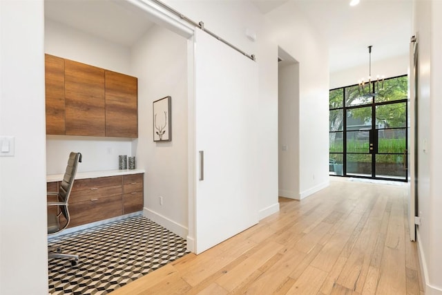 4103 Ridgelea Dr, Austin, TX 78731 - corridor with light wood finished floors, an office area, a chandelier, and recessed lighting