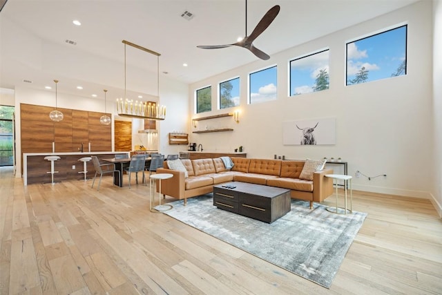 4103 Ridgelea Dr, Austin, TX 78731 - living room with a towering ceiling, a ceiling fan, light wood-style floors, plenty of natural light, and recessed lighting
