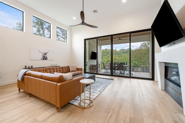 4103 Ridgelea Dr, Austin, TX 78731 - living room with a ceiling fan, light wood-type flooring, recessed lighting, and a glass covered fireplace