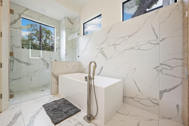 4103 Ridgelea Dr, Austin, TX 78731 - full bath featuring marble tiled flooring, a soaking tub, a marble finish shower, stone wall, and tile walls