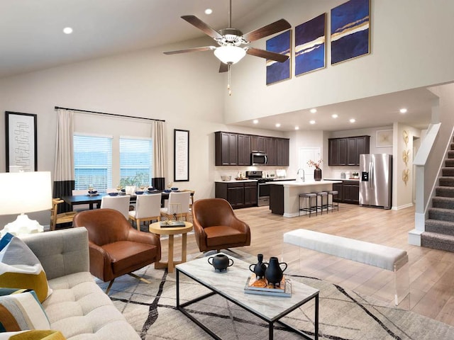 1728 S Main St, Kyle, TX 78640 - living room featuring high vaulted ceiling, light wood finished floors, stairway, a ceiling fan, and recessed lighting