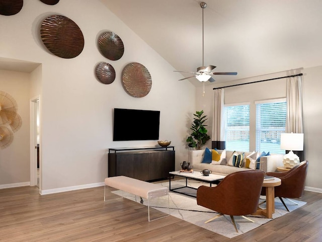 1728 S Main St, Kyle, TX 78640 - living room featuring baseboards, light wood-type flooring, a ceiling fan, and high vaulted ceiling