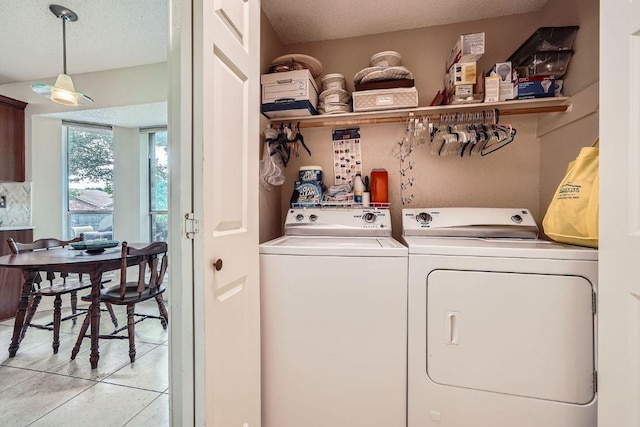12711 Possum Hollow Dr, Austin, TX 78729 - laundry room featuring independent washer and dryer, a textured ceiling, and light tile patterned floors
