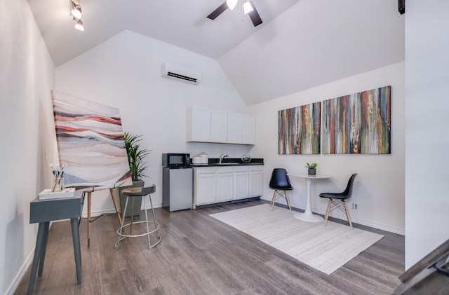 2702 Bonnie Rd, Austin, TX 78703 - living area with an AC wall unit, wood finished floors, a ceiling fan, and lofted ceiling
