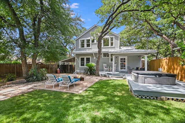 2702 Bonnie Rd, Austin, TX 78703 - rear view of house with a hot tub, a patio, a fenced backyard, and a metal roof