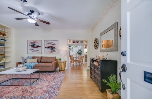 2702 Bonnie Rd, Austin, TX 78703 - living area with light wood-style floors, ornamental molding, and a ceiling fan