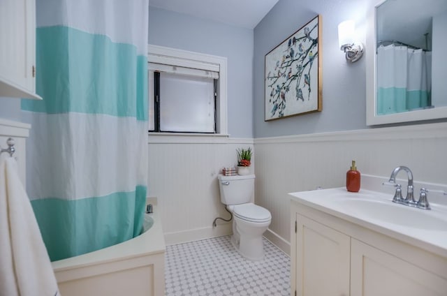 2702 Bonnie Rd, Austin, TX 78703 - bathroom featuring a wainscoted wall, vanity, tile patterned floors, and shower / bath combo with shower curtain