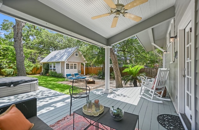2702 Bonnie Rd, Austin, TX 78703 - wooden terrace featuring a hot tub, a fenced backyard, and an outdoor structure