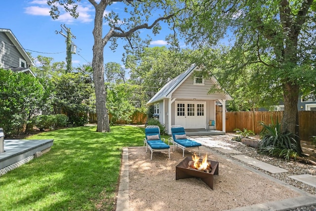 2702 Bonnie Rd, Austin, TX 78703 - fenced backyard with an outbuilding and an outdoor fire pit