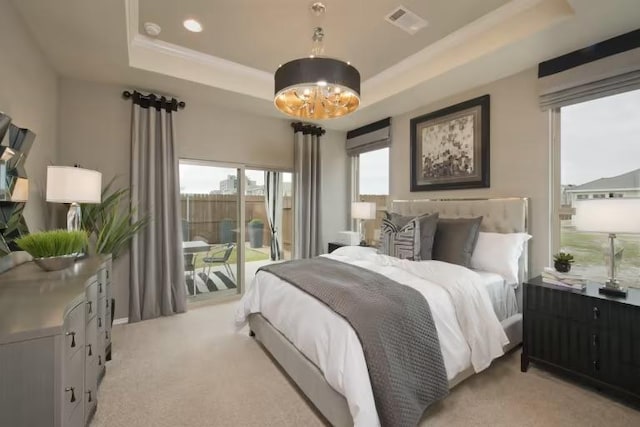 229 Regatta Trl, Leander, TX 78641 - bedroom featuring a tray ceiling, access to exterior, light carpet, and a chandelier