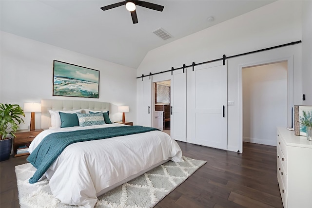 212 Ferryboat Ln, New Braunfels, TX 78130 - bedroom with a barn door, lofted ceiling, dark wood finished floors, and a ceiling fan