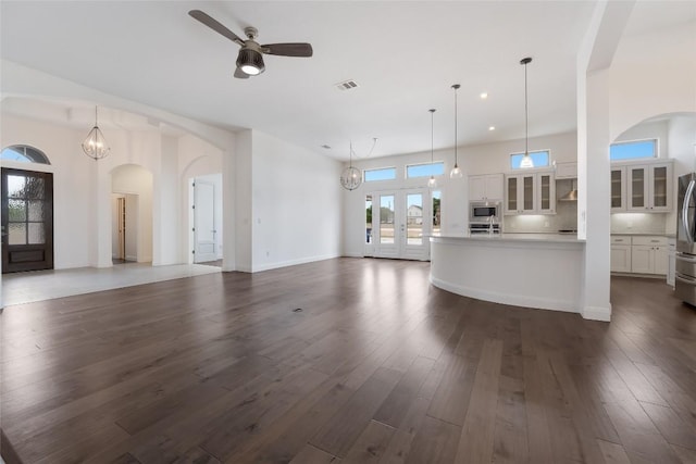 212 Ferryboat Ln, New Braunfels, TX 78130 - unfurnished living room featuring a ceiling fan, plenty of natural light, dark wood-style flooring, arched walkways, and recessed lighting