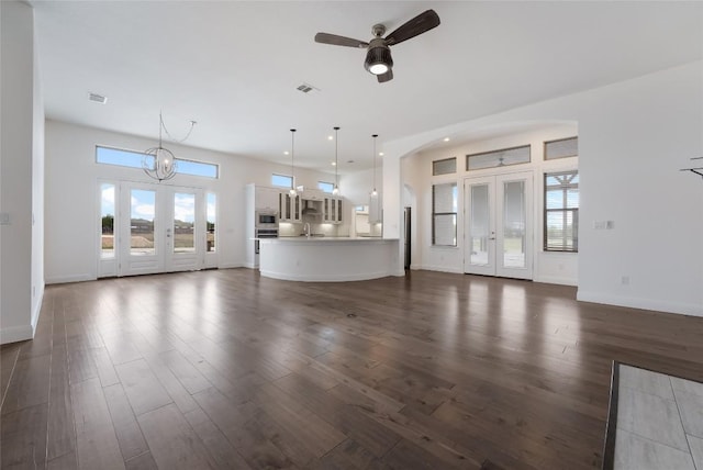 212 Ferryboat Ln, New Braunfels, TX 78130 - unfurnished living room with ceiling fan, dark wood finished floors, recessed lighting, and arched walkways
