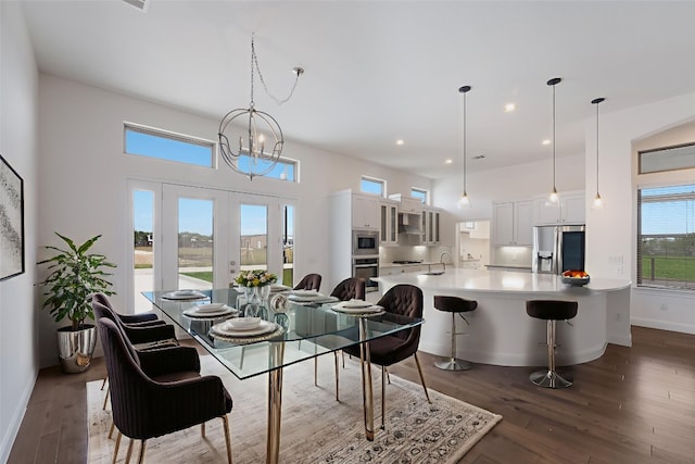 212 Ferryboat Ln, New Braunfels, TX 78130 - dining area with a chandelier, dark wood-style flooring, recessed lighting, and a towering ceiling