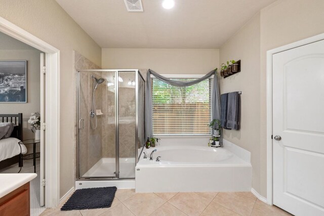 1802 Tall Chief, Leander, TX 78641 - bathroom featuring a garden tub, tile patterned flooring, a shower stall, vanity, and connected bathroom