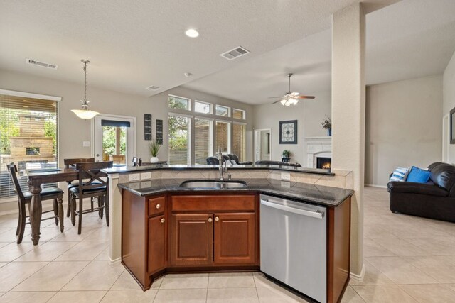 1802 Tall Chief, Leander, TX 78641 - kitchen featuring stainless steel dishwasher, open floor plan, ceiling fan, light tile patterned floors, and pendant lighting