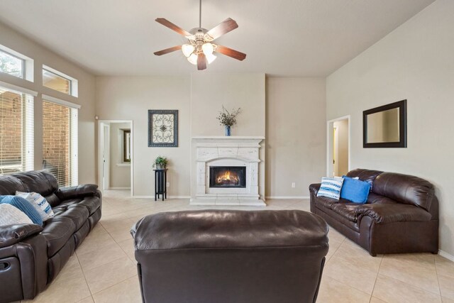 1802 Tall Chief, Leander, TX 78641 - living area featuring light tile patterned floors, ceiling fan, and a lit fireplace