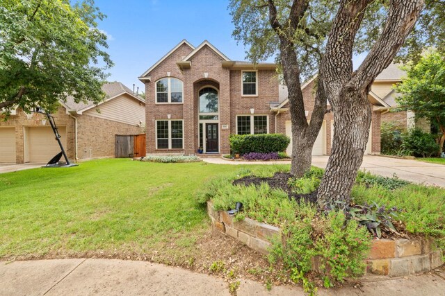 1802 Tall Chief, Leander, TX 78641 - traditional-style house with concrete driveway, brick siding, and a front lawn