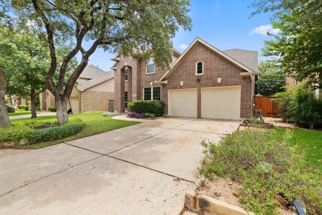 1802 Tall Chief, Leander, TX 78641 - traditional-style home featuring brick siding, a garage, and driveway