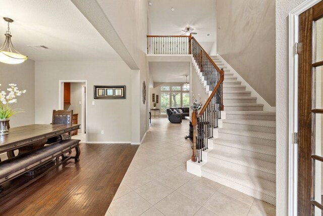 1802 Tall Chief, Leander, TX 78641 - foyer entrance featuring stairs, a ceiling fan, wood finished floors, and a high ceiling