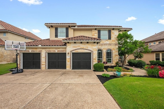4605 Bat Falcon Dr, Austin, TX 78738 - mediterranean / spanish house featuring driveway, a tile roof, an attached garage, a front yard, and stone siding