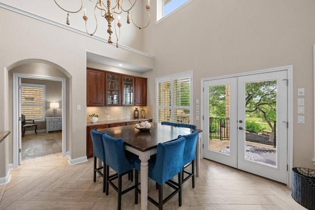 4605 Bat Falcon Dr, Austin, TX 78738 - dining room with a high ceiling, french doors, and arched walkways