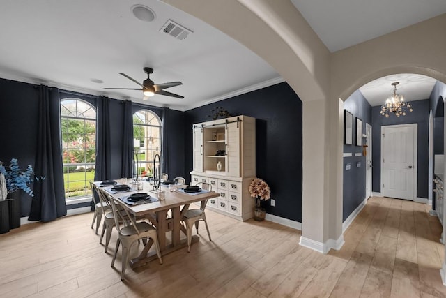 4605 Bat Falcon Dr, Austin, TX 78738 - dining area with arched walkways, light wood-type flooring, ceiling fan, and a chandelier