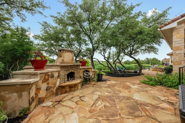 4605 Bat Falcon Dr, Austin, TX 78738 - view of patio / terrace with an outdoor stone fireplace