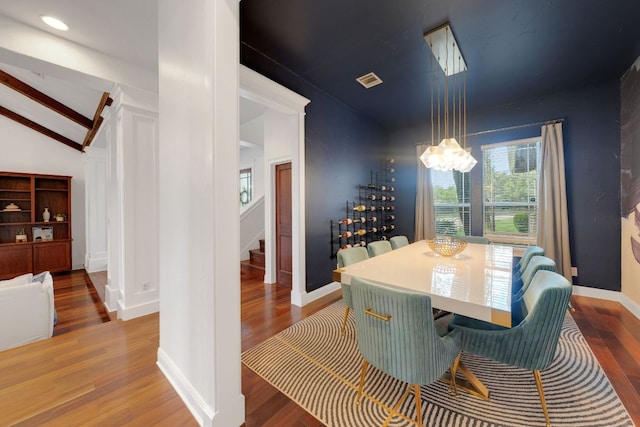 2705 Pyramid Dr, Austin, TX 78734 - dining room with lofted ceiling, wood finished floors, a chandelier, and stairs