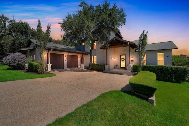 2705 Pyramid Dr, Austin, TX 78734 - view of front of home featuring an attached garage, driveway, a front yard, and stone siding