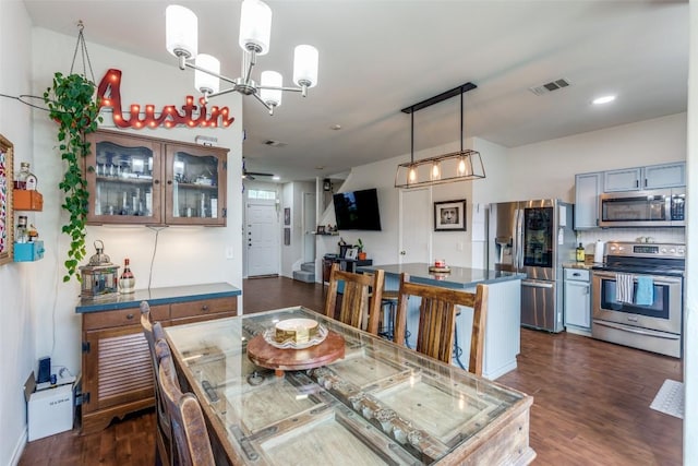 18701 Golden Eagle Way, Elgin, TX 78621 - dining area with dark wood-style floors and a chandelier