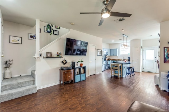18701 Golden Eagle Way, Elgin, TX 78621 - living area with stairs, dark wood finished floors, and ceiling fan