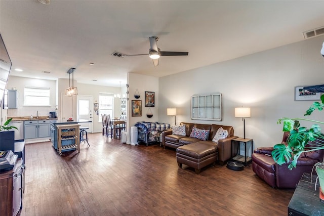 18701 Golden Eagle Way, Elgin, TX 78621 - living area featuring ceiling fan, dark wood-style flooring, and a chandelier