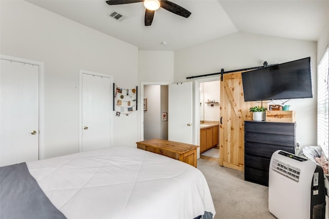 18701 Golden Eagle Way, Elgin, TX 78621 - bedroom with lofted ceiling, light colored carpet, a barn door, ensuite bath, and multiple windows
