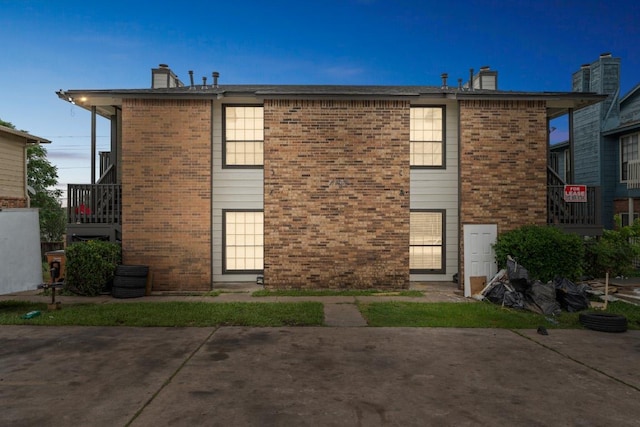11303 Nicole Cv, Austin, TX 78753 - rear view of house featuring a chimney, brick siding, and a patio area