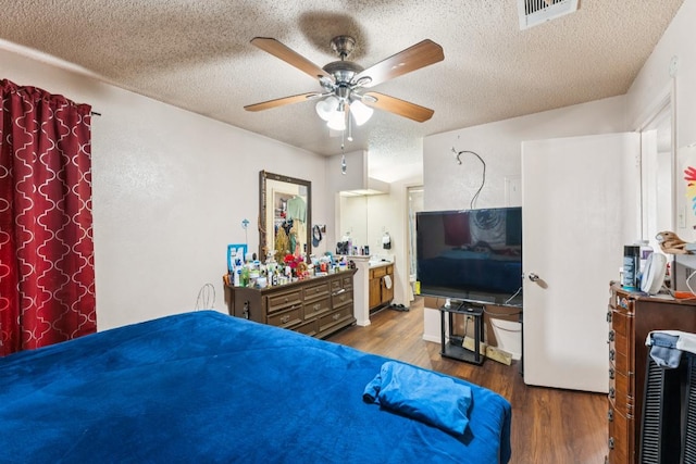 11303 Nicole Cv, Austin, TX 78753 - bedroom with wood finished floors, a textured ceiling, and a ceiling fan