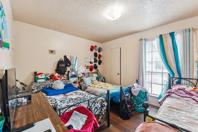11303 Nicole Cv, Austin, TX 78753 - bedroom featuring a textured ceiling and wood finished floors