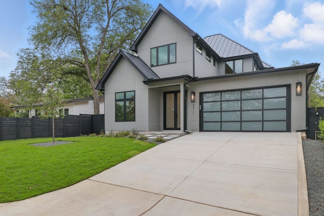 2711 Pegram, Austin, TX 78757 - view of front facade with stucco siding, concrete driveway, a standing seam roof, a metal roof, and an attached garage