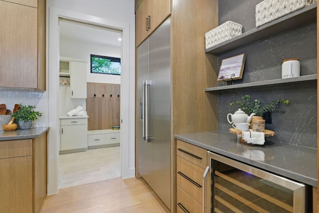 2711 Pegram, Austin, TX 78757 - kitchen with stainless steel built in refrigerator, open shelves, wine cooler, tasteful backsplash, and light wood-style flooring