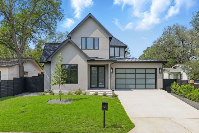 2711 Pegram, Austin, TX 78757 - view of front of home featuring stucco siding, a standing seam roof, driveway, and a metal roof