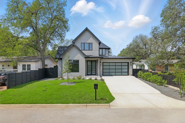2711 Pegram, Austin, TX 78757 - view of front of house featuring stucco siding, driveway, a standing seam roof, and a metal roof