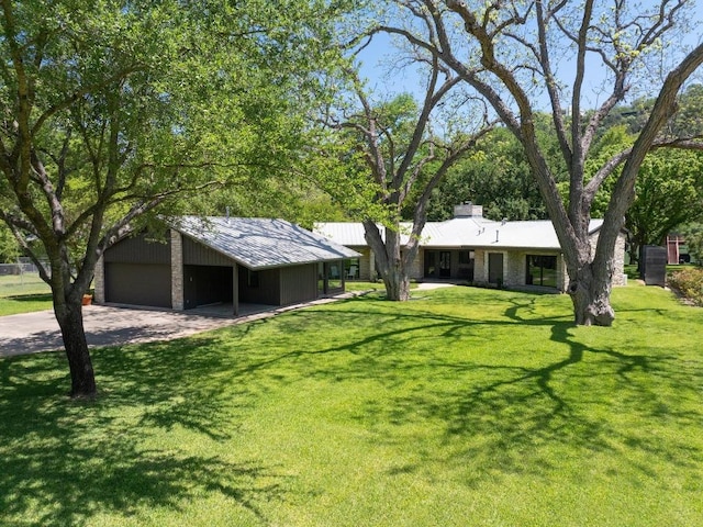 2401 Manana St, Austin, TX 78730 - view of front of home with a front yard, driveway, and an outbuilding