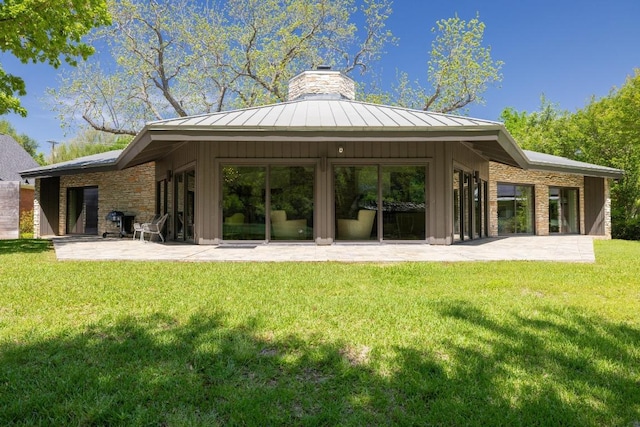 2401 Manana St, Austin, TX 78730 - rear view of property with a standing seam roof, a patio, a chimney, and a metal roof