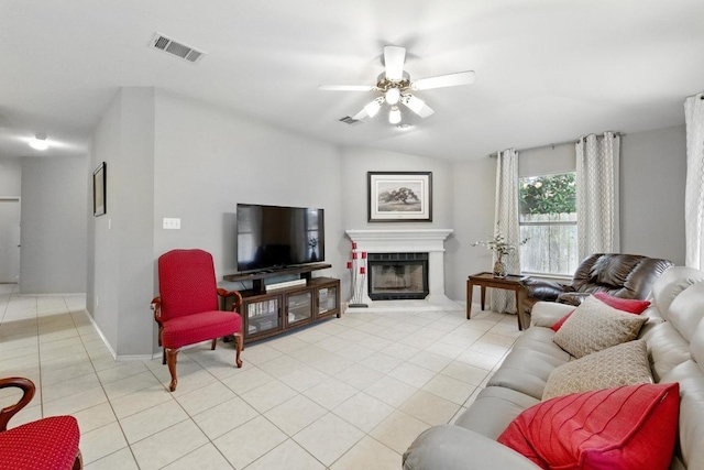 9602 Tea Rose Trl, Austin, TX 78748 - living area with light tile patterned floors, a ceiling fan, a fireplace with raised hearth, and lofted ceiling