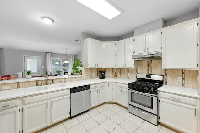 9602 Tea Rose Trl, Austin, TX 78748 - kitchen featuring appliances with stainless steel finishes, under cabinet range hood, light countertops, and light tile patterned floors