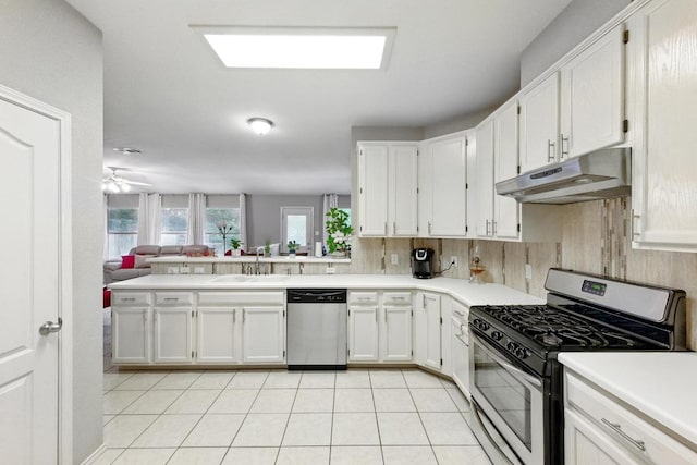 9602 Tea Rose Trl, Austin, TX 78748 - kitchen featuring appliances with stainless steel finishes, under cabinet range hood, open floor plan, and white cabinetry